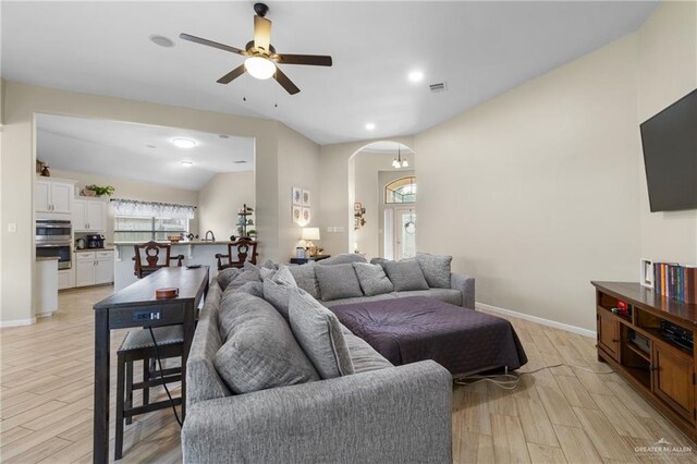 2003 N 44th Ln, Mcallen, TX 78501 - living room featuring ceiling fan, light wood-type flooring, arched walkways, baseboards, and lofted ceiling
