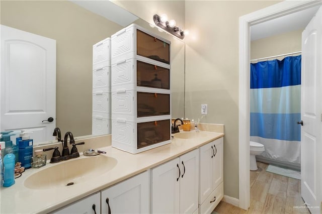 2003 N 44th Ln, Mcallen, TX 78501 - full bathroom featuring toilet, double vanity, a shower with curtain, and wood finished floors