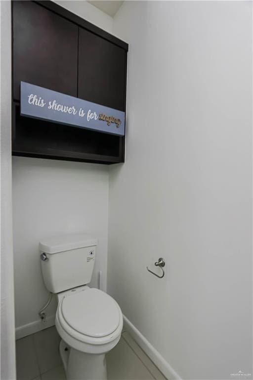 bathroom featuring tile patterned flooring, toilet, and baseboards