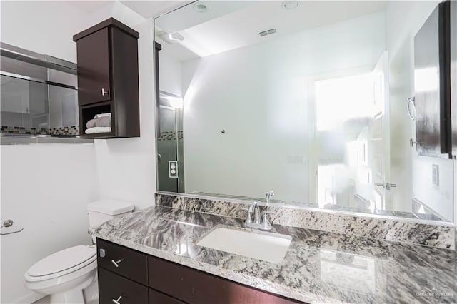 bathroom featuring toilet, visible vents, and vanity