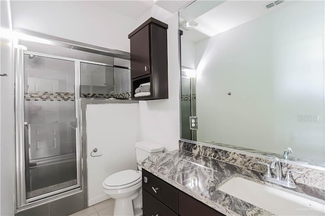 bathroom with visible vents, vanity, a shower stall, and toilet