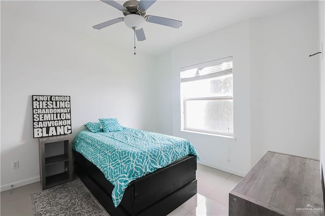 bedroom with a ceiling fan and baseboards