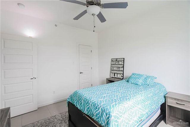 bedroom with baseboards, a ceiling fan, and light tile patterned flooring