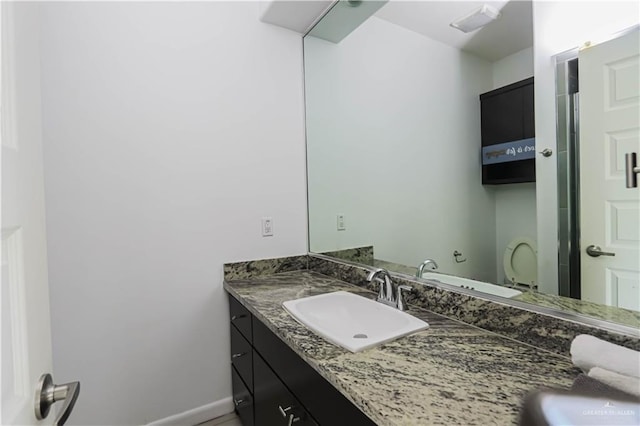 bathroom with vanity and baseboards