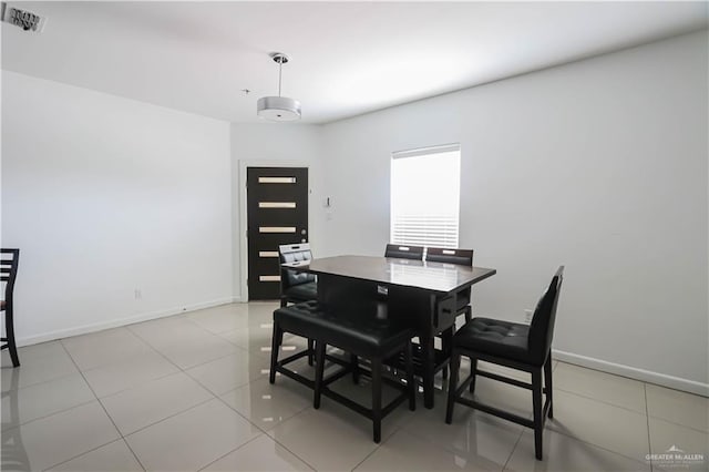 dining space with light tile patterned floors, baseboards, and visible vents