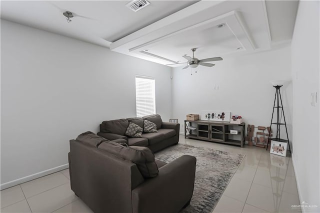 living room with tile patterned flooring, visible vents, ceiling fan, and baseboards