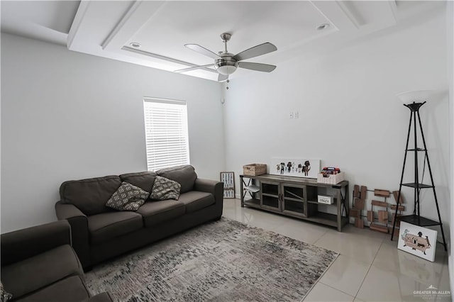 tiled living area with ceiling fan