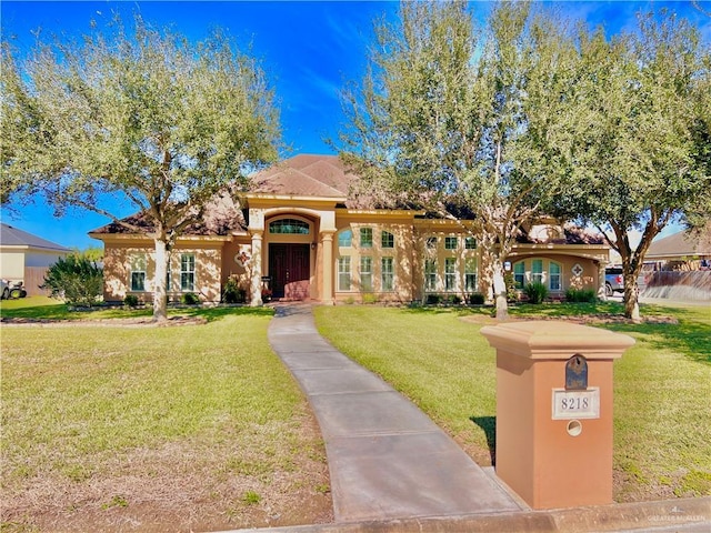 mediterranean / spanish home featuring a front yard