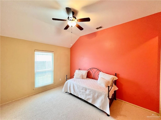 carpeted bedroom featuring vaulted ceiling and ceiling fan