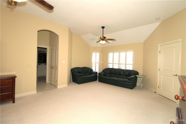 carpeted living room with vaulted ceiling and ceiling fan