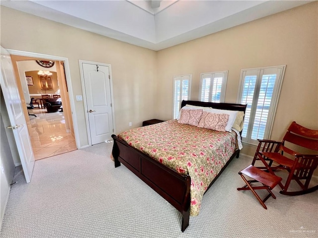 bedroom featuring tile patterned floors and ceiling fan with notable chandelier