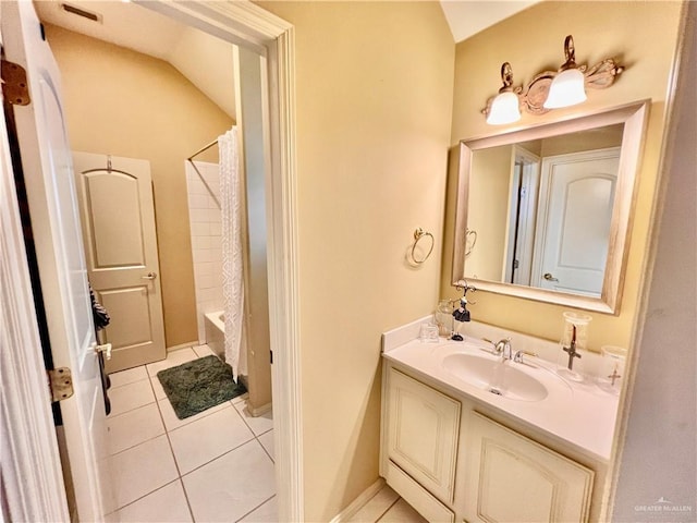 bathroom featuring tile patterned flooring, vanity, lofted ceiling, and shower / bath combo