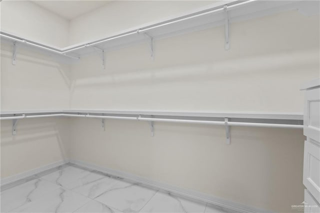 3108 Travis St, Weslaco, TX 78599 - walk in closet featuring light marble finish flooring