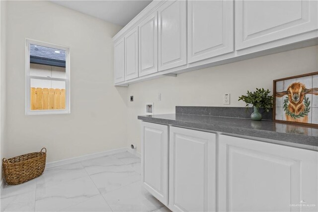 3108 Travis St, Weslaco, TX 78599 - laundry room featuring cabinet space, light marble finish floors, electric dryer hookup, and washer hookup