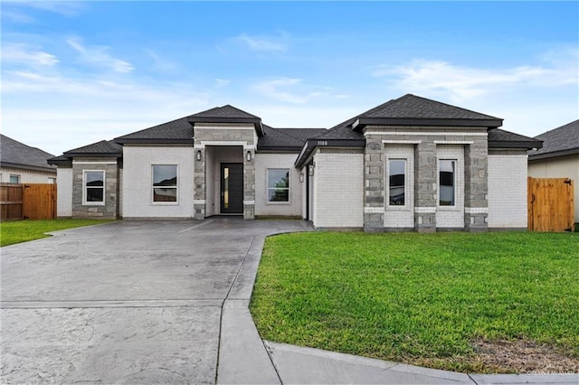 3108 Travis St, Weslaco, TX 78599 - prairie-style home featuring concrete driveway, a shingled roof, and brick siding