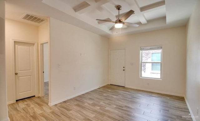 spare room with ceiling fan, light hardwood / wood-style flooring, beamed ceiling, and coffered ceiling