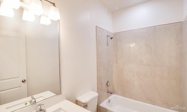 full bathroom featuring vanity, toilet, and tiled shower / bath