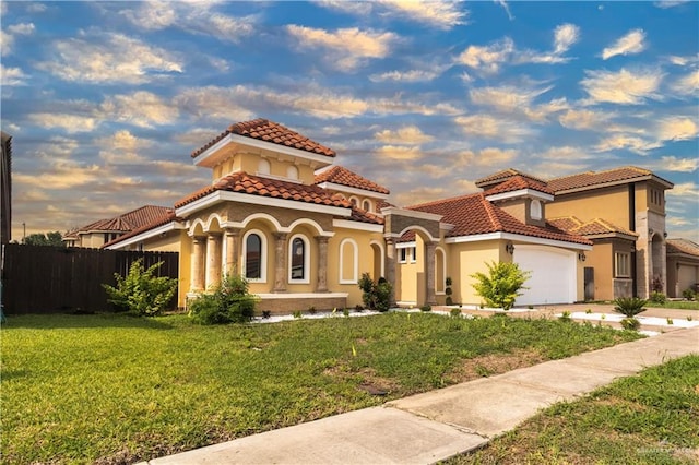 3210 Salvador Ave, Edinburg, TX 78539 - mediterranean / spanish-style house featuring a garage, a tiled roof, stucco siding, fence, and a yard