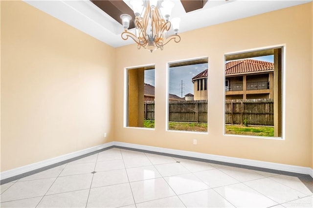3210 Salvador Ave, Edinburg, TX 78539 - empty room featuring an inviting chandelier, baseboards, and light tile patterned floors