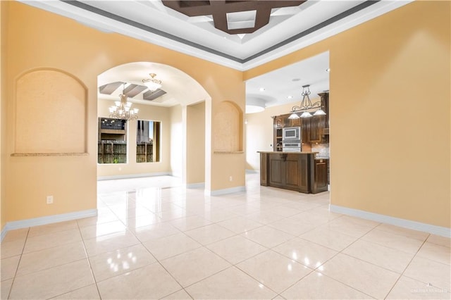 3210 Salvador Ave, Edinburg, TX 78539 - empty room featuring light tile patterned flooring, a chandelier, arched walkways, coffered ceiling, and baseboards