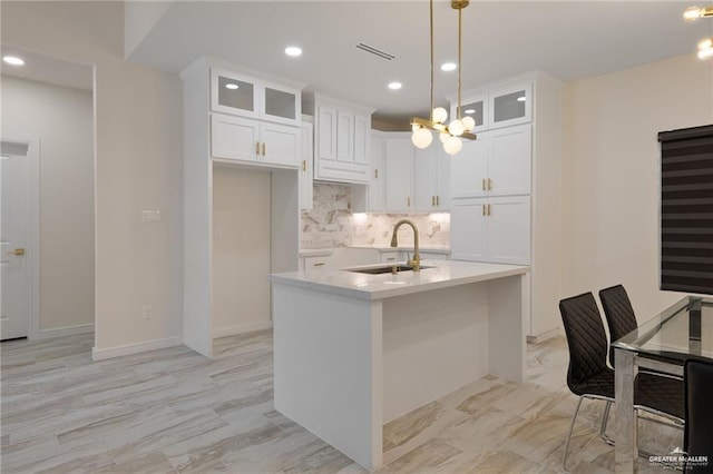 1923 Lime St, San Juan, TX 78589 - kitchen featuring a sink, backsplash, glass insert cabinets, white cabinets, and recessed lighting