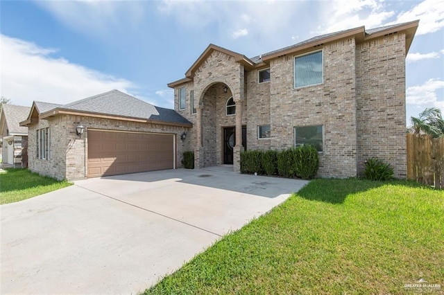 view of front of house with a front yard and a garage