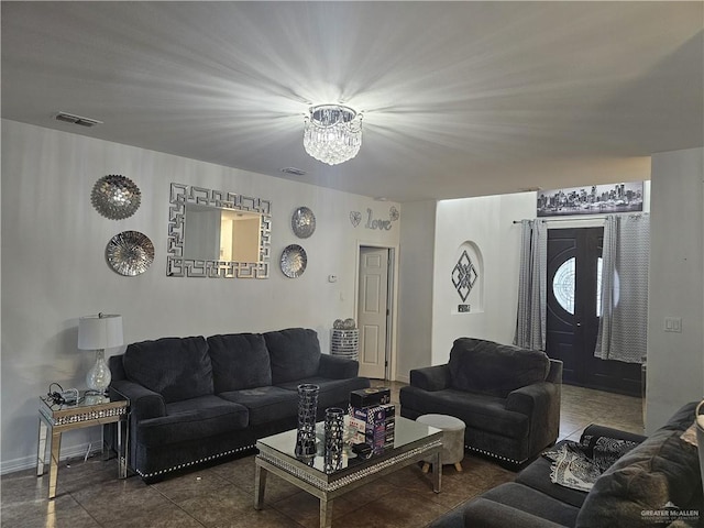 tiled living room featuring a chandelier