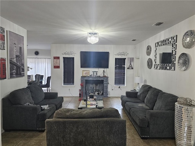 living room featuring tile patterned flooring and a chandelier