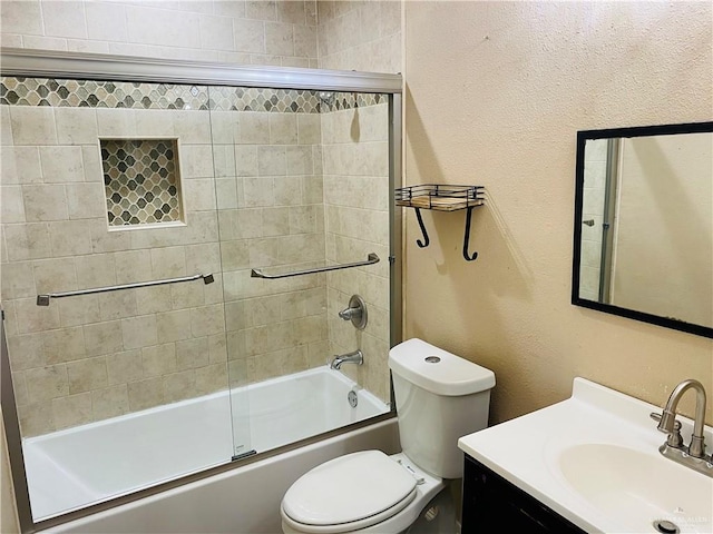 full bathroom with enclosed tub / shower combo, vanity, and toilet