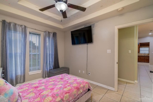 3831 Spicewood Dr, Edinburg, TX 78542 - bedroom with light tile patterned flooring, a raised ceiling, baseboards, and a ceiling fan