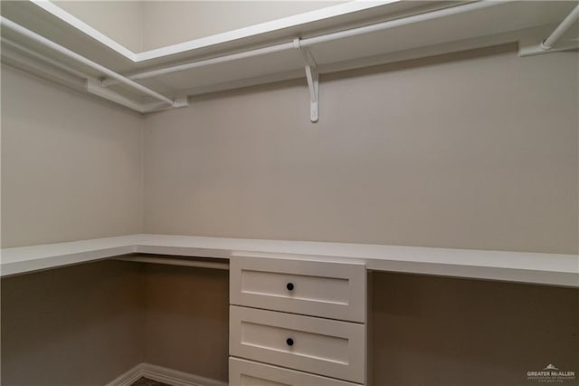 spacious closet featuring built in study area