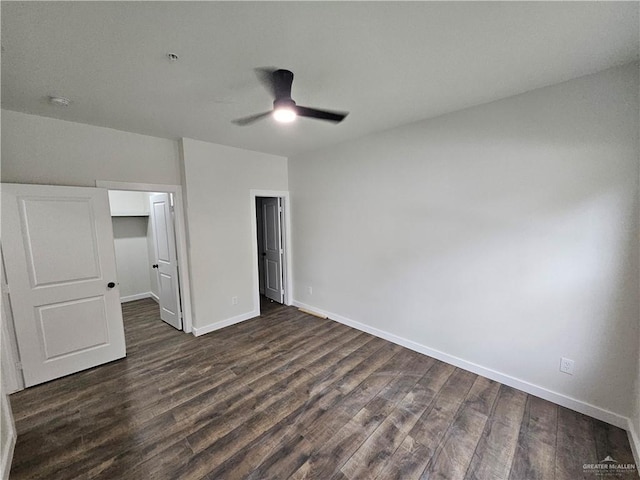 unfurnished bedroom featuring dark wood-type flooring and ceiling fan