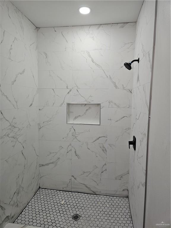 bathroom with a tile shower