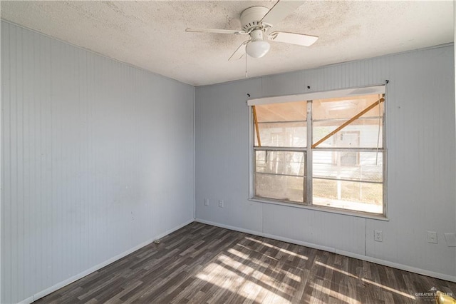 unfurnished room with ceiling fan, a textured ceiling, and dark wood-type flooring