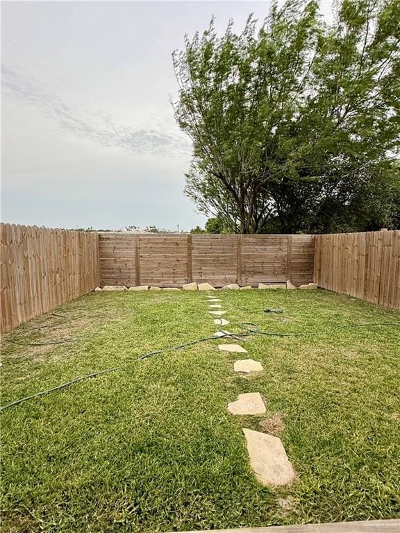 view of yard with a fenced backyard