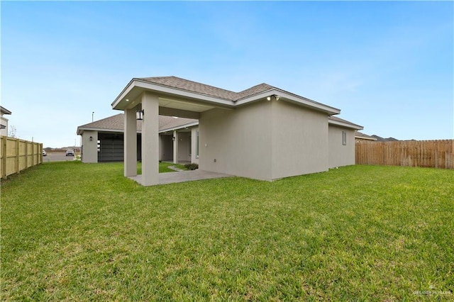 rear view of property with a lawn and a patio area