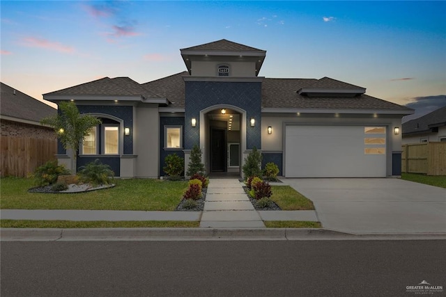 view of front of house featuring a yard and a garage