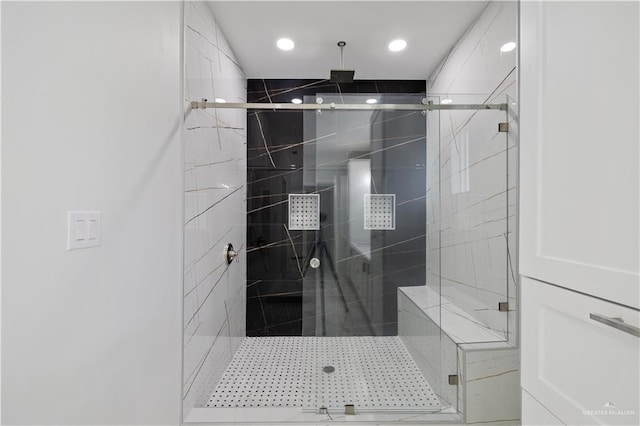 bathroom with a shower with shower door