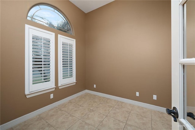 unfurnished room featuring light tile patterned floors