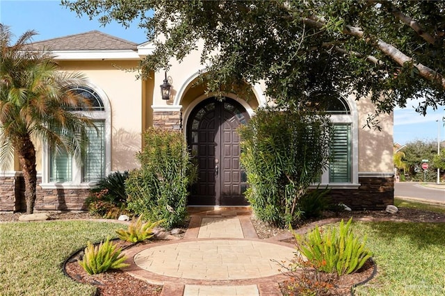 doorway to property featuring a yard