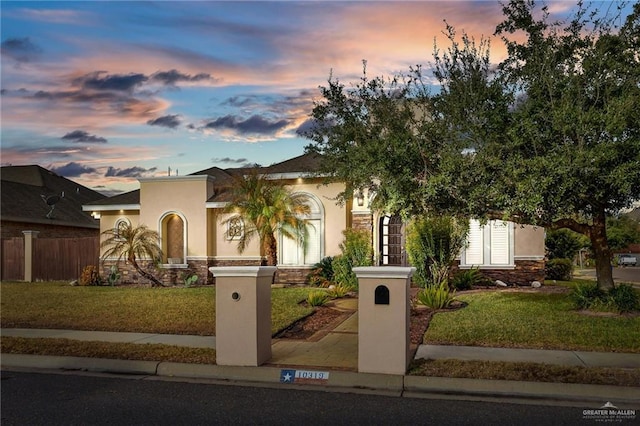 mediterranean / spanish house with a lawn