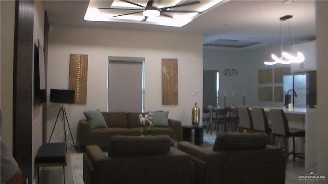 interior space with ceiling fan with notable chandelier