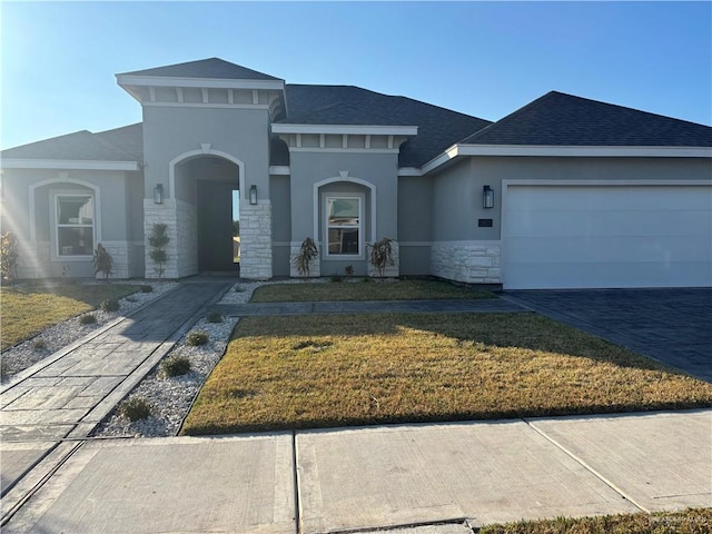 view of front facade with a front yard and a garage