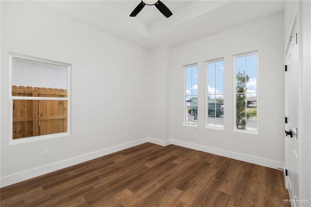 unfurnished room with dark wood-type flooring and ceiling fan