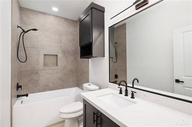 full bathroom featuring toilet, vanity, and tiled shower / bath