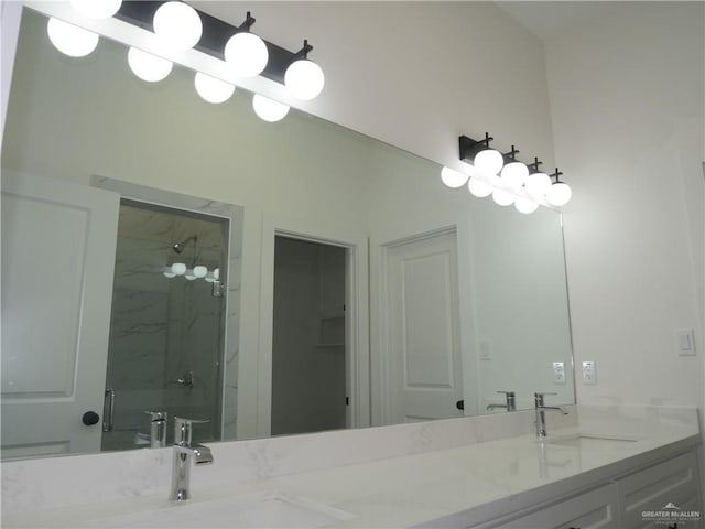 bathroom with vanity and a shower with door