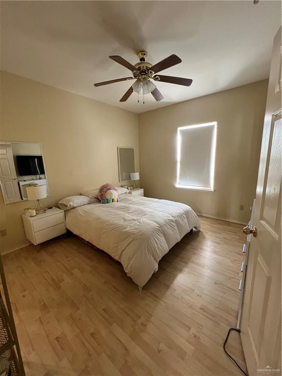 bedroom with ceiling fan and light hardwood / wood-style flooring