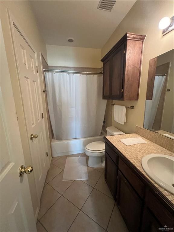 full bathroom featuring toilet, shower / bath combo, vanity, and tile patterned floors