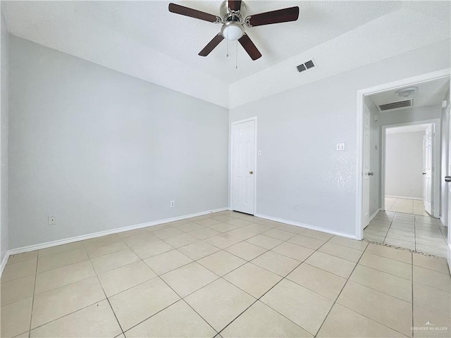 spare room with visible vents, baseboards, and light tile patterned floors