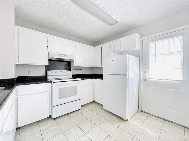 kitchen with dark countertops, white appliances, white cabinetry, and under cabinet range hood